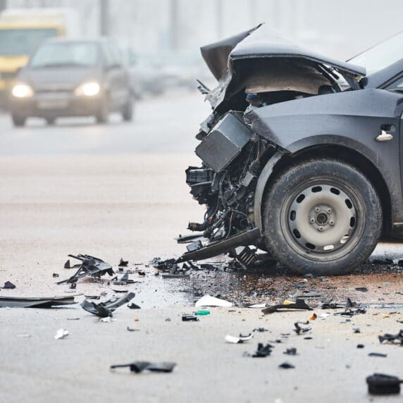 frontal car crash damage on a black car