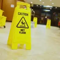 Yellow caution wet floor sign in a building lobby. Slip and Fall Accidents in Las Vegas Hotels and Casinos