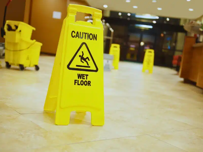 Yellow caution wet floor sign in a building lobby. Slip and Fall Accidents in Las Vegas Hotels and Casinos