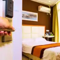 Hand opening a hotel room door with handle. Sue a casino or hotel for enabling sex trafficking