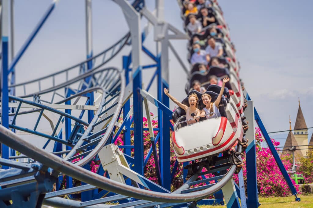 people on a roller coaster at an amusement park