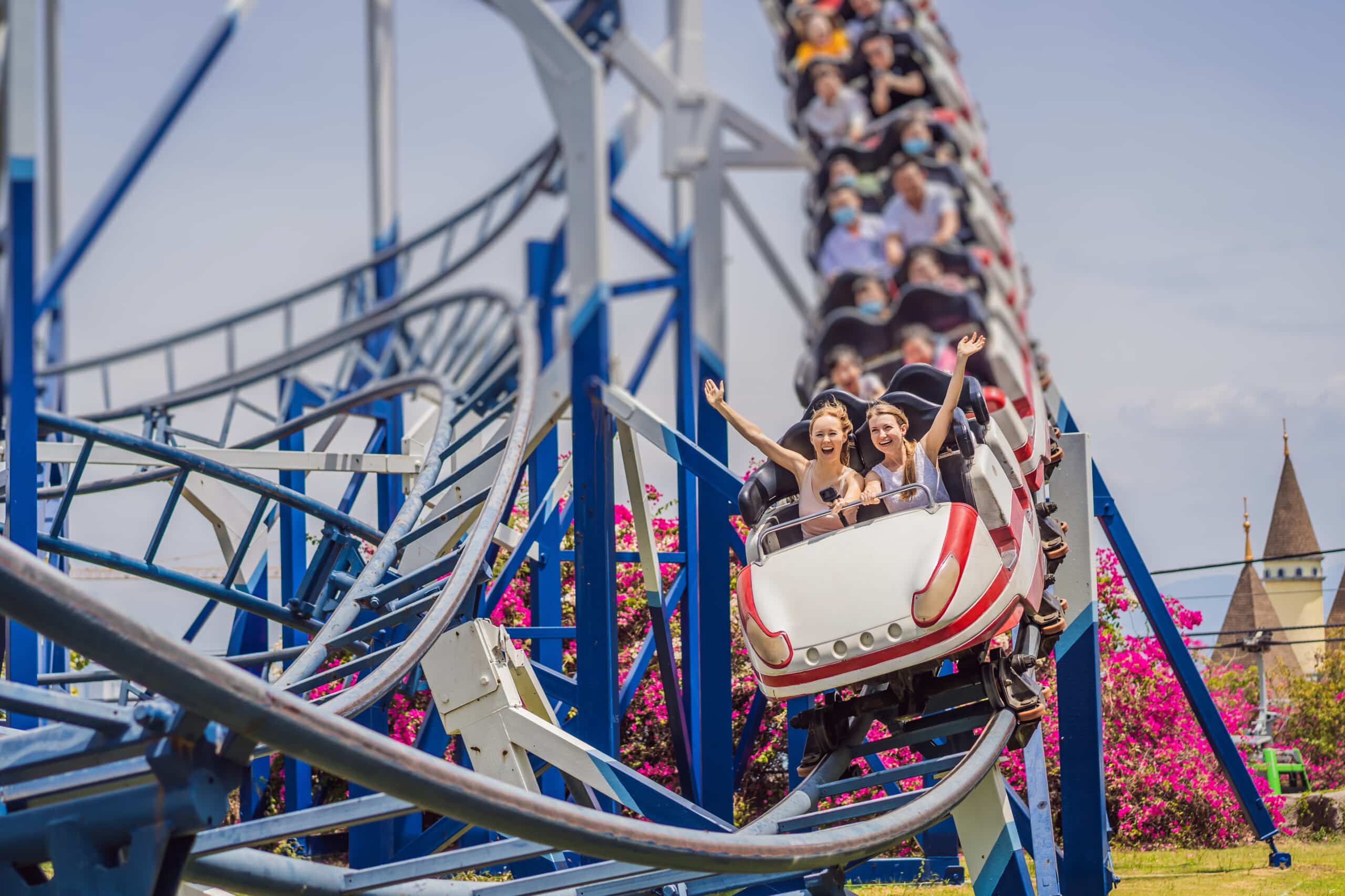 people on a roller coaster at an amusement park